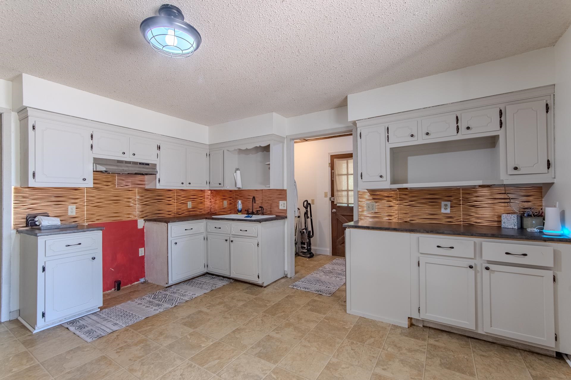 3280 Ramer Selmer Road Ramer, TN 38367 - Photo 10 of 23 a kitchen with granite countertop a sink and cabinets
