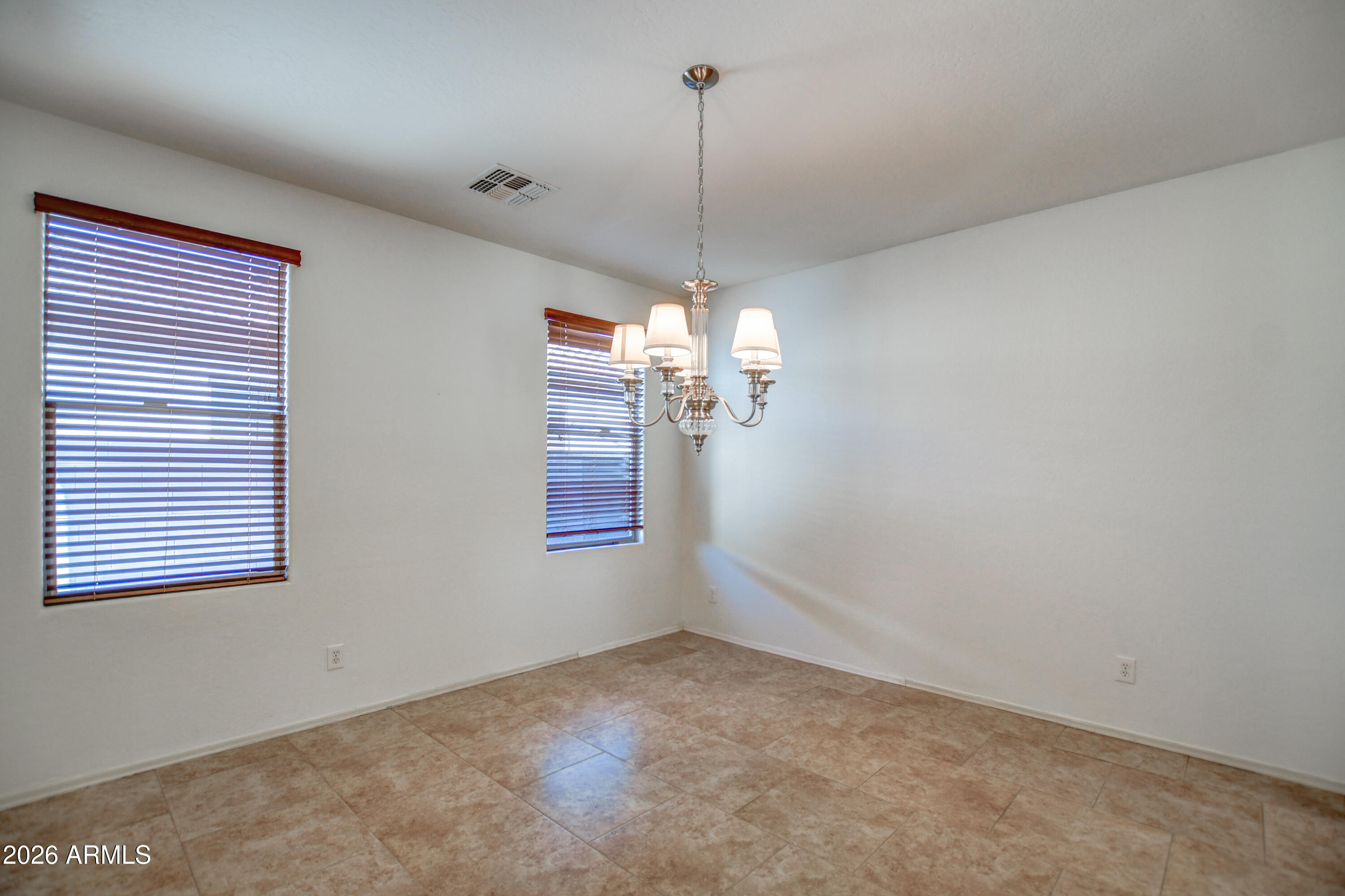 3078 East Muirfield Street Gilbert, AZ 85298 - Photo 20 of 92 a view of a room with a chandelier fan and windows