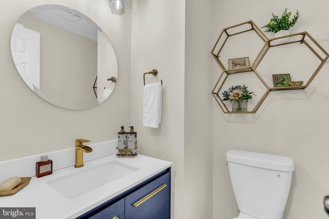 a balcony with wooden floor table and chairs