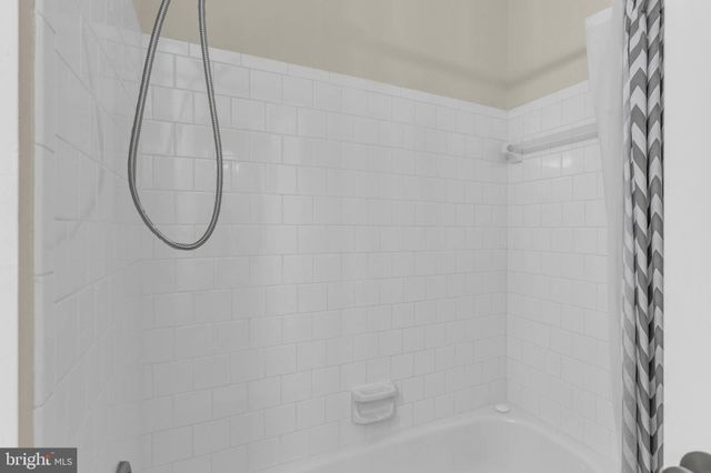 a bathroom with a sink a mirror and shower