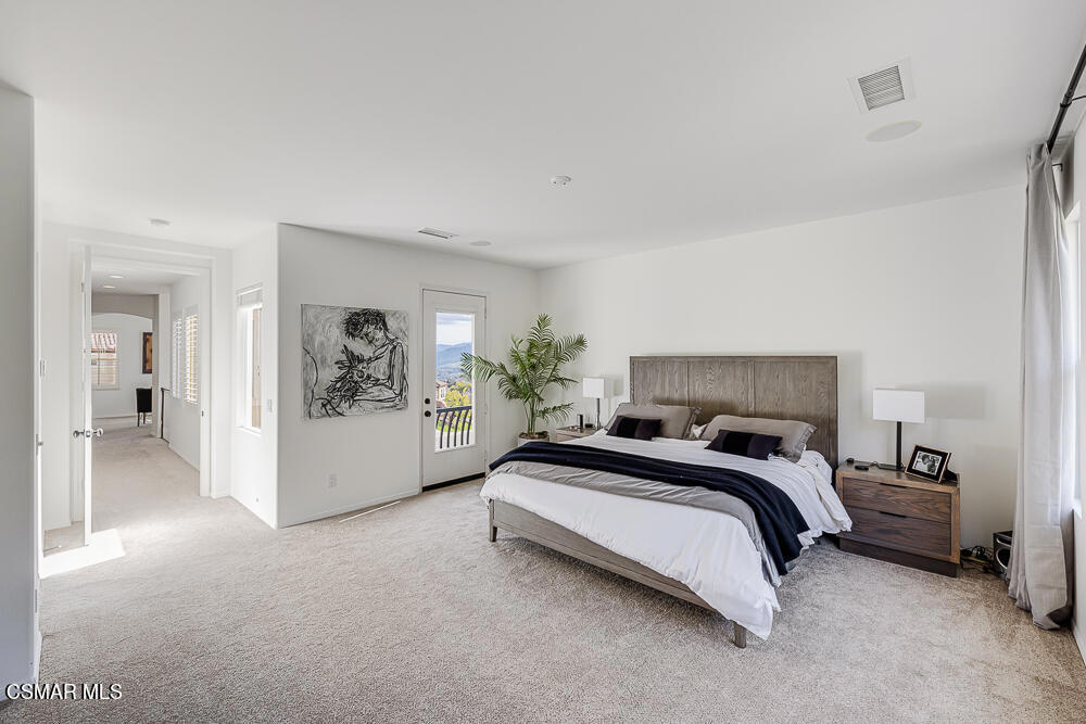 6103 Deerhill Road Oak Park, CA 91377 - Photo 19 of 40 a spacious bedroom with a bed and a cabinets