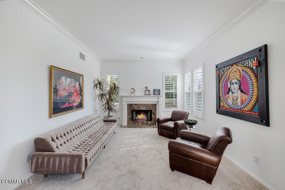 6103 Deerhill Road Oak Park, CA 91377 - Photo 8 of 40 a living room with furniture a fireplace and painted walls