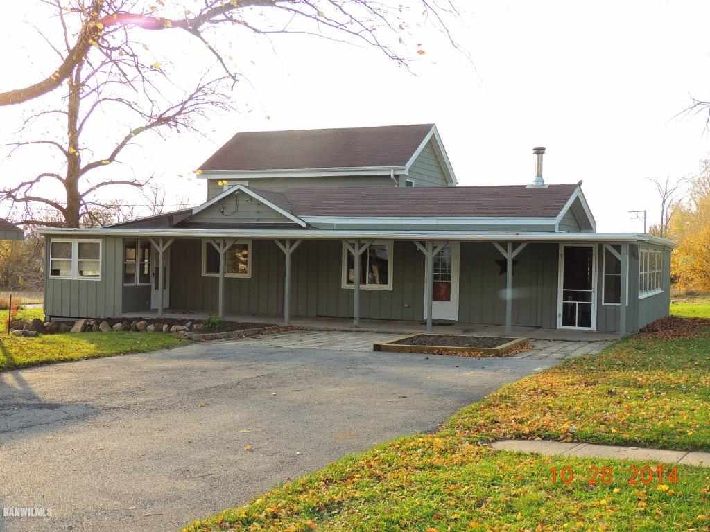 9691 Trask Bridge Road Pecatonica, IL 61063 - Photo 1 of 23 a front view of a house with a garden