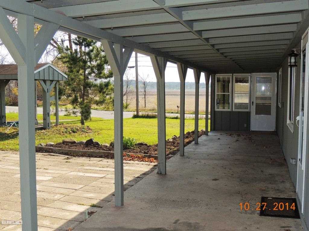 9691 Trask Bridge Road Pecatonica, IL 61063 - Photo 5 of 23 a view of a porch with furniture and floor to ceiling window