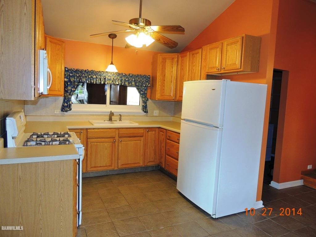 9691 Trask Bridge Road Pecatonica, IL 61063 - Photo 6 of 23 a kitchen with a refrigerator a stove a sink and dishwasher
