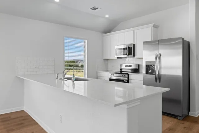a kitchen with a refrigerator and a sink