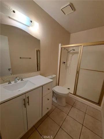 a bathroom with a granite countertop sink a toilet and a mirror