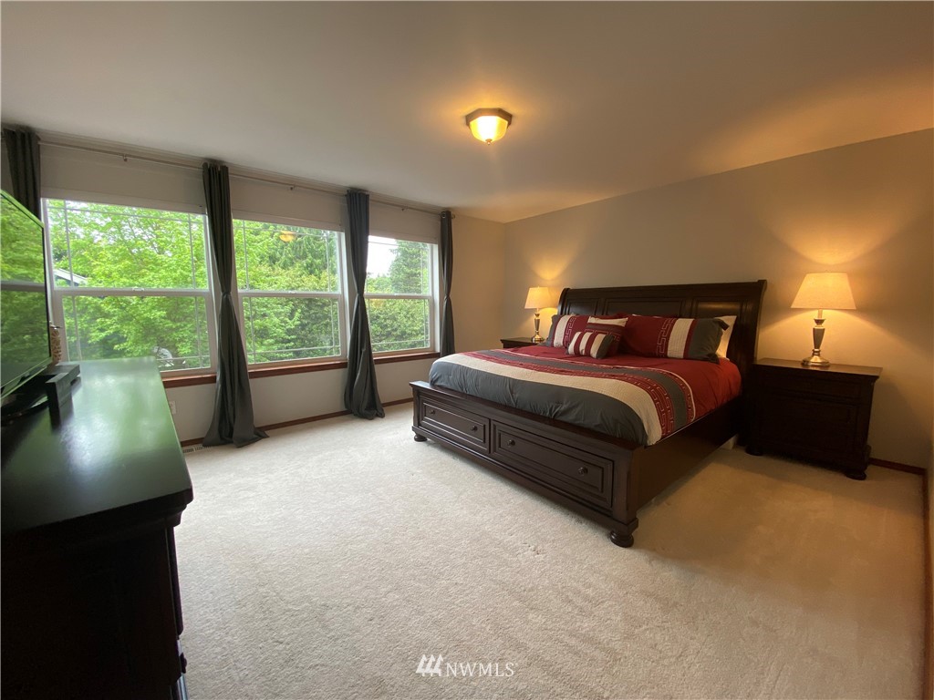1815 Northeast 27th Court Renton, WA 98056 - Photo 14 of 31 a bedroom with a bed and large window