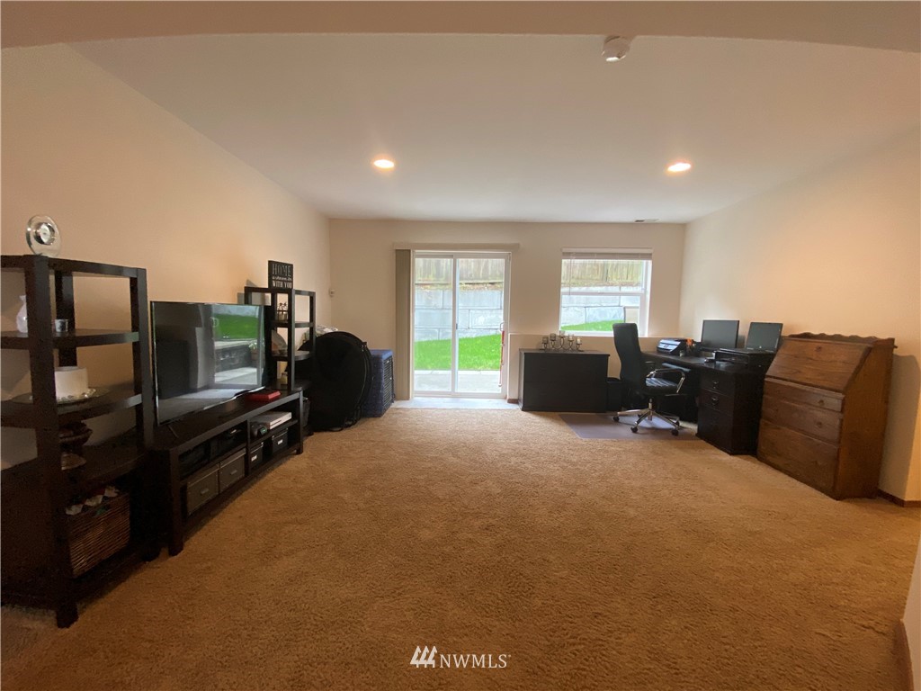 1815 Northeast 27th Court Renton, WA 98056 - Photo 21 of 31 a living room with furniture a flat screen tv and a window