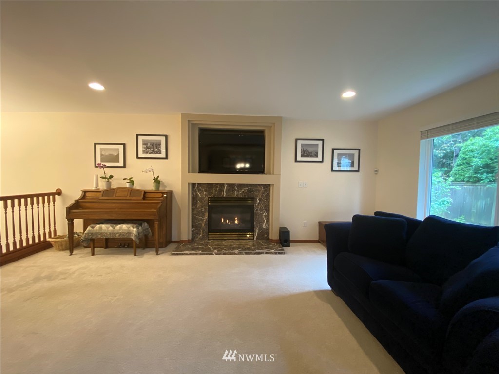 1815 Northeast 27th Court Renton, WA 98056 - Photo 8 of 31 a living room with furniture and a fireplace