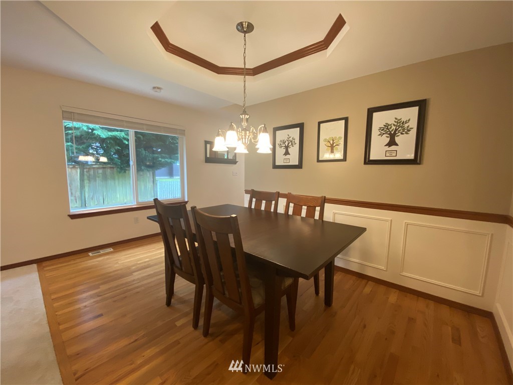 1815 Northeast 27th Court Renton, WA 98056 - Photo 9 of 31 a view of a dining room with furniture window and wooden floor
