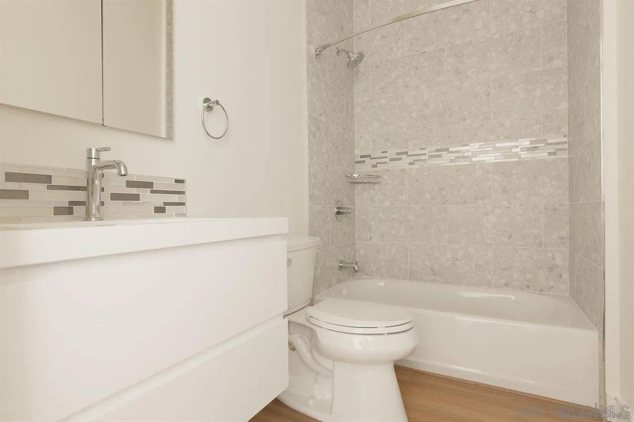 8292 High Street La Mesa, CA 91941 - Photo 12 of 23 a bathroom with a bathtub shower sink vanity and toilet