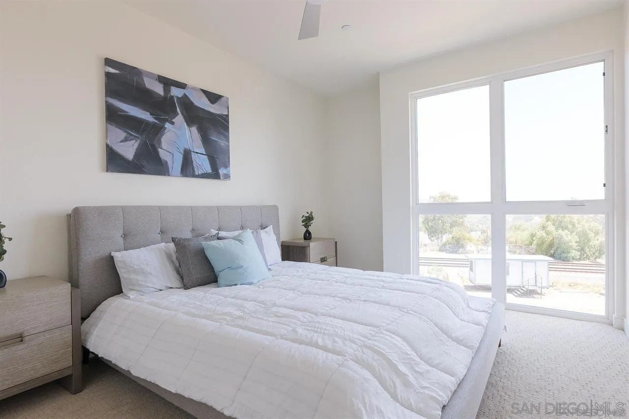 8292 High Street La Mesa, CA 91941 - Photo 13 of 23 a bedroom with a bed and a painting on the wall