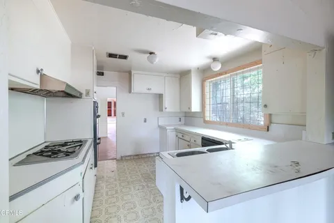 a kitchen that has a sink and a stove