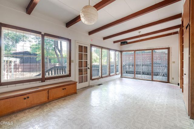 a big room with wooden floor and windows