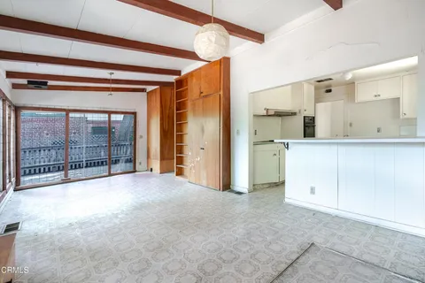 a view of a kitchen with large windows