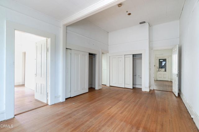 a view of a room with wooden floor