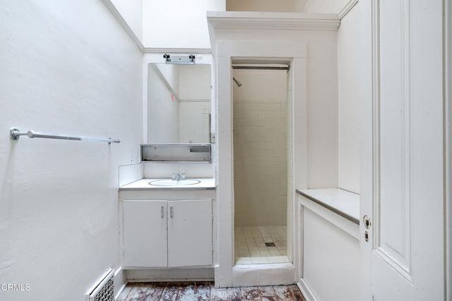 a bathroom with a granite countertop sink a toilet and shower