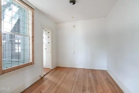 a view of a room with wooden floor and windows