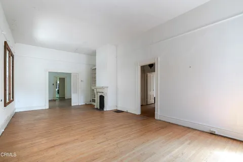 an empty room with wooden floor and closet