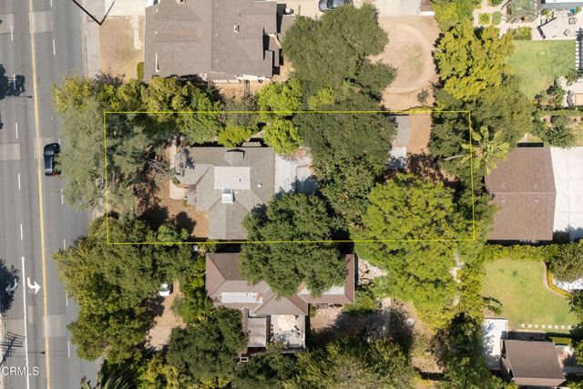 an aerial view of a house with a yard