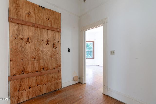 a view of an empty room with wooden floor