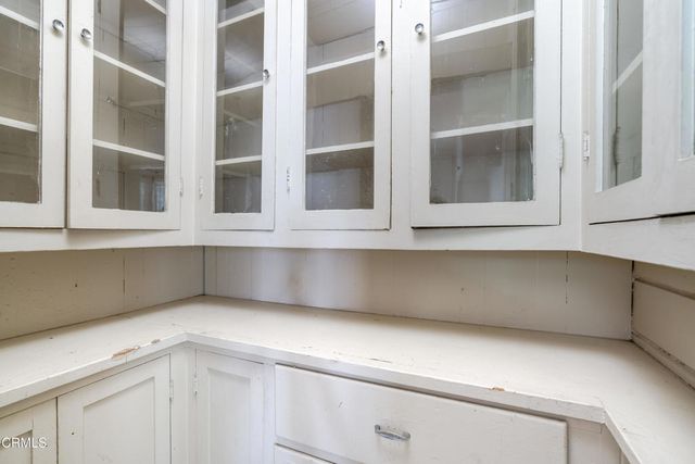 a view of an empty kitchen with white cabinets