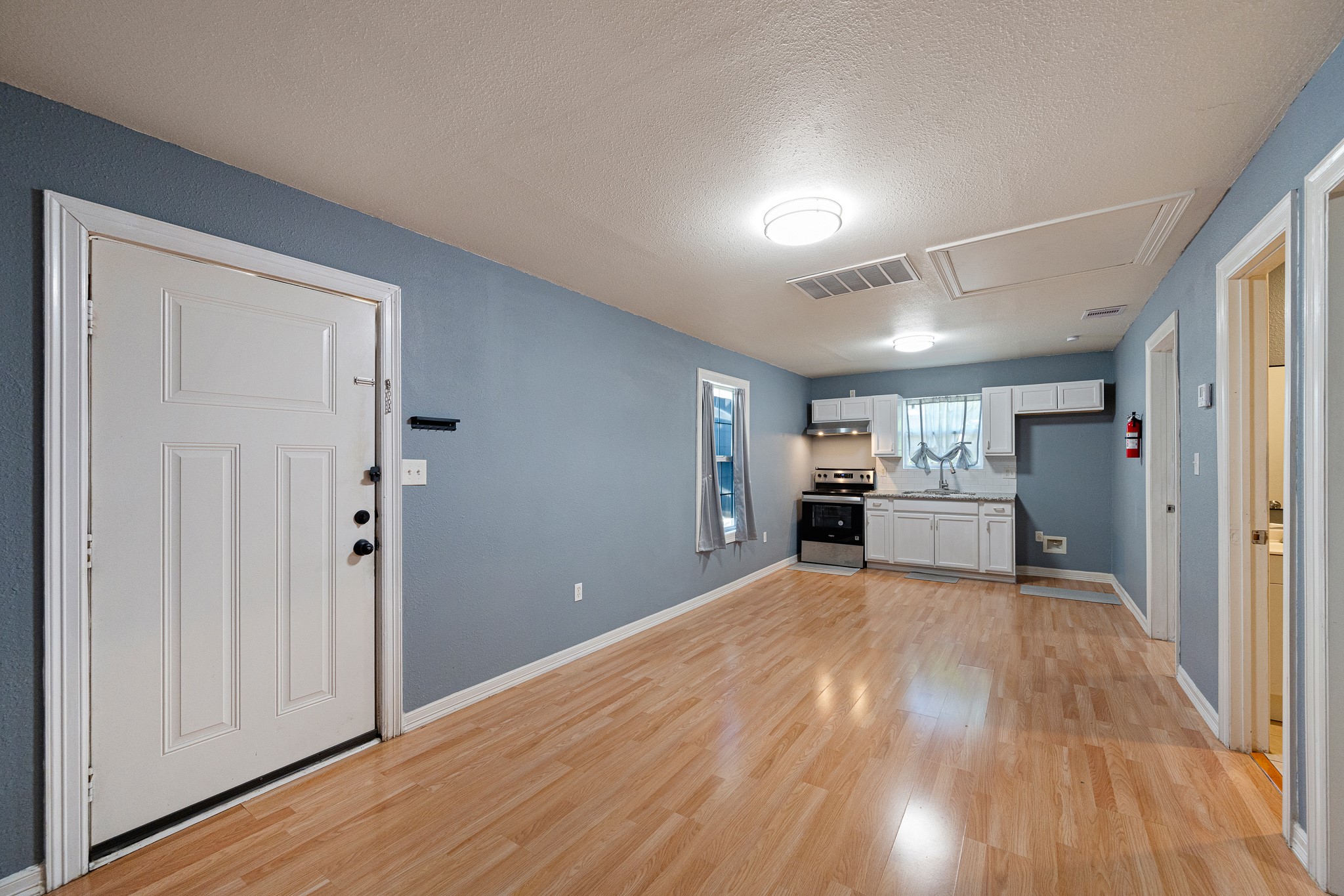 7815 Harding Street, Unit B Houston, TX 77012 - Photo 7 of 21 Discover the seamless flow from the inviting living room to the bright kitchen/dining combo, creating the perfect space for entertaining and everyday living.