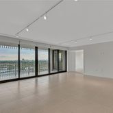 wooden floor in an empty room with a large window
