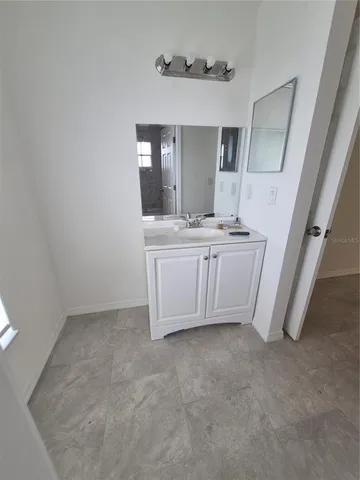 a view of kitchen with granite countertop cabinets and sink