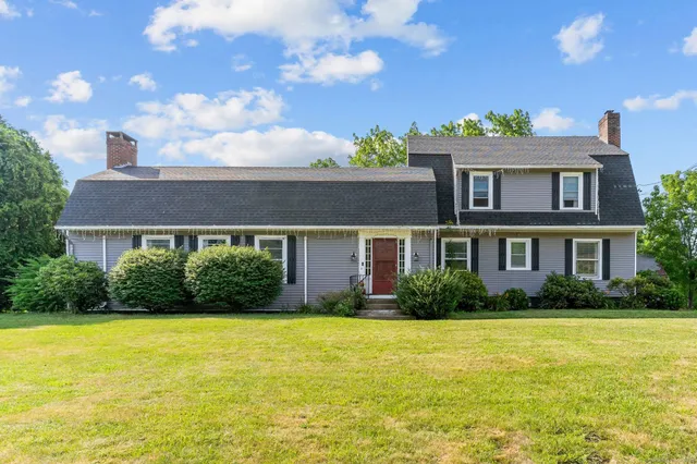 a front view of house with yard and green space