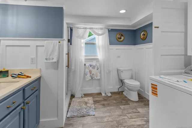 a bathroom with a toilet sink and shower