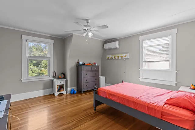 a bedroom with a bed dresser and a window