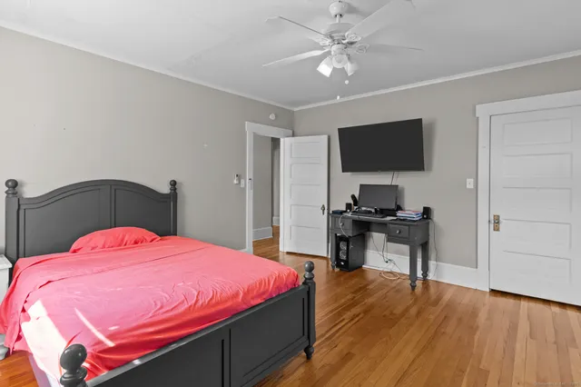 a bedroom with a bed and a flat screen tv