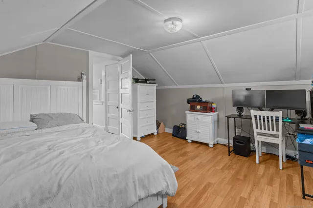 a bedroom with a bed and a chair