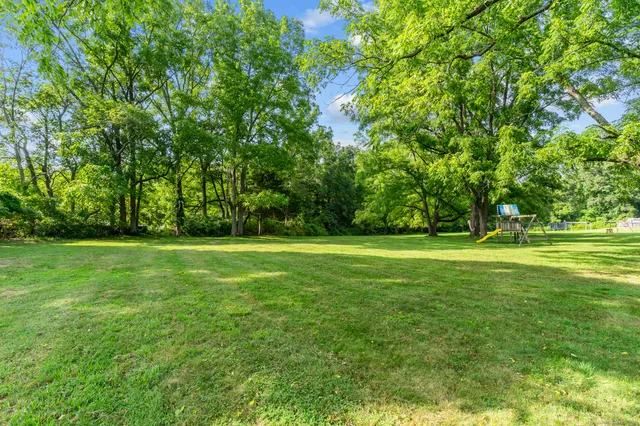 a view of outdoor space with deck and yard