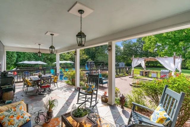 a view of a patio with couches plants dining table and chairs