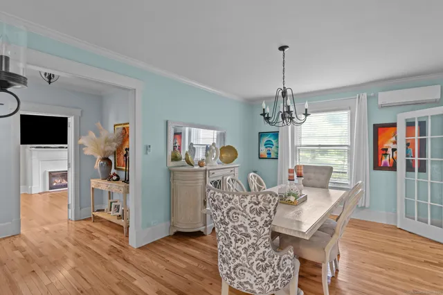 a view of a dining room with furniture wooden floor and chandelier