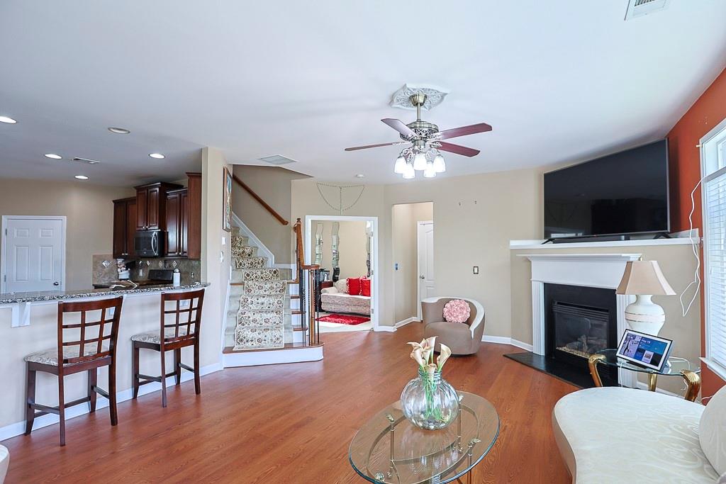 300 Hampton Place Canton, GA 30115 - Photo 29 of 82 a living room with furniture a fireplace and a flat screen tv