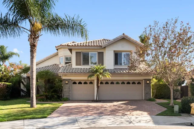 a view of a house with a yard and potted plants