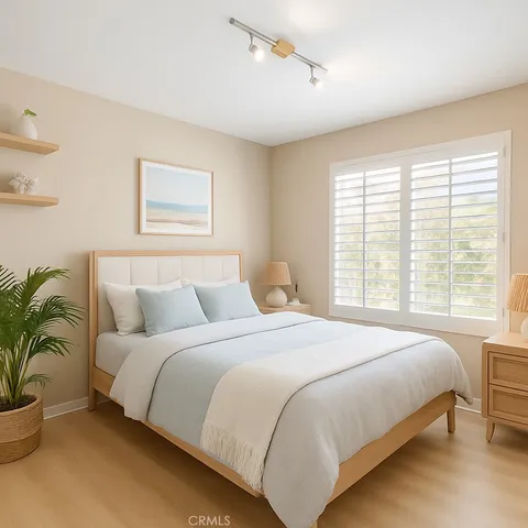 a bedroom with a large bed and a potted plant