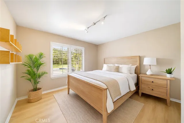 a bed room with a bed and a potted plant