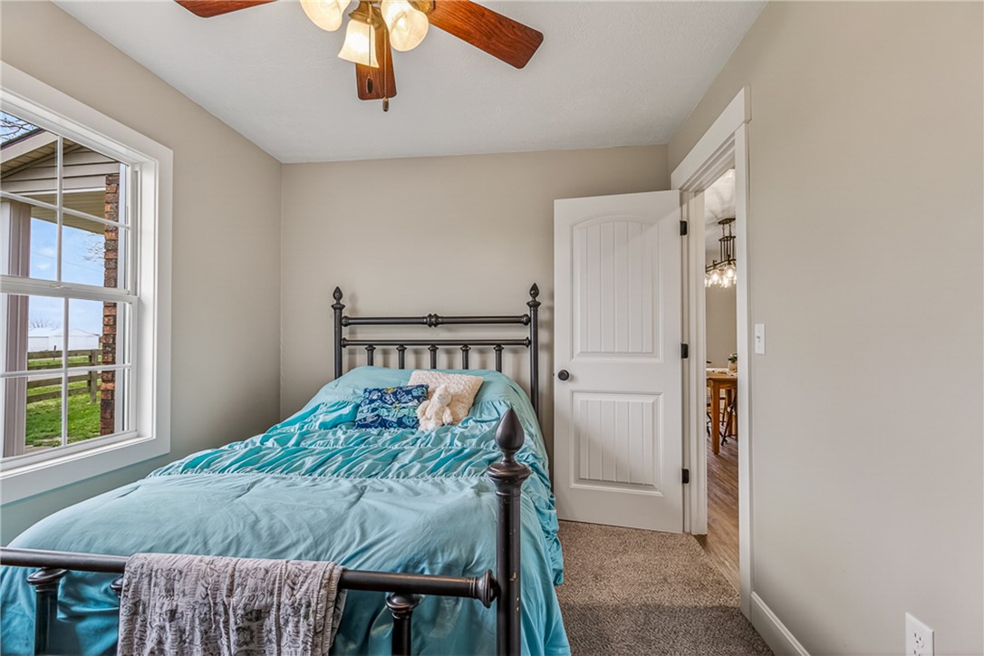 8700 Quaker Trace Road Camden, OH 45311 - Photo 14 of 34 This cozy bedroom offers a tranquil retreat with a refreshing view of the outdoors.