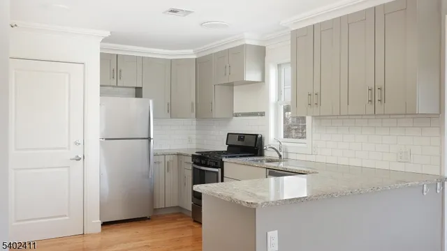 a kitchen with a refrigerator a stove a microwave and cabinets