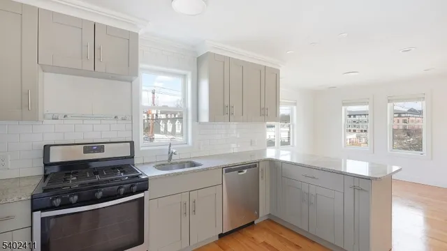 a kitchen with cabinets appliances and a window