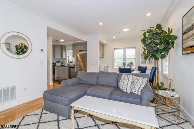 a living room with furniture and a chandelier