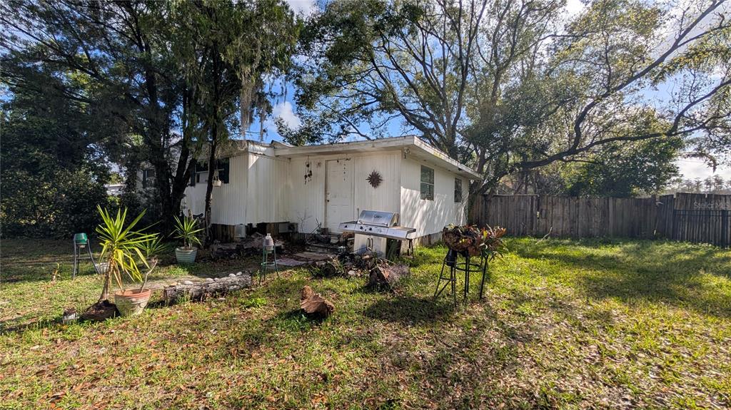 a backyard of a house with table and chairs