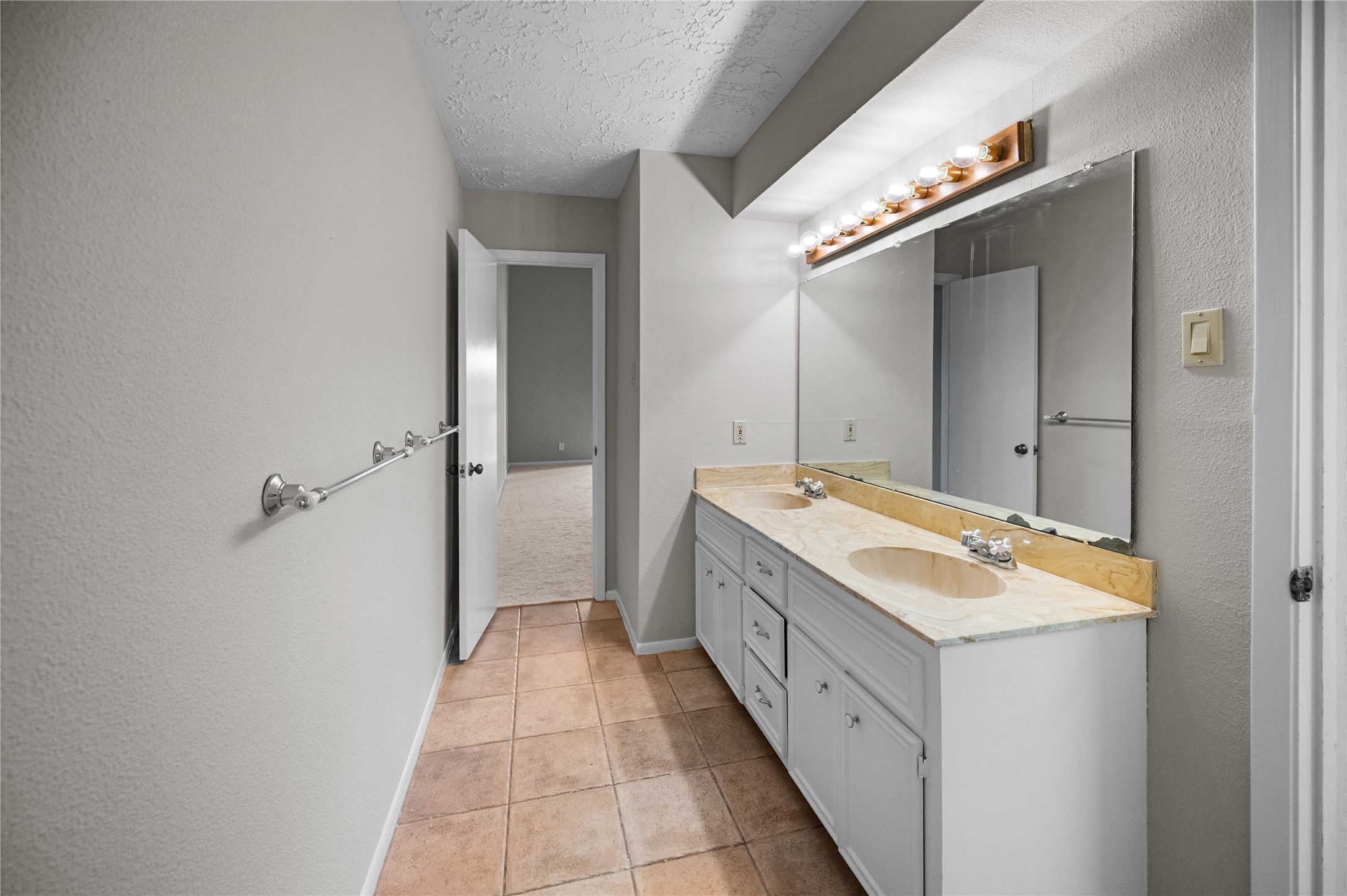705 Davis Road League City, TX 77573 - Photo 13 of 26 Primary bathroom with double sinks, tons of storage space and tile flooring.