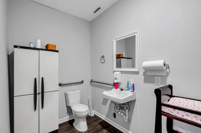 a bathroom with a sink toilet and a mirror