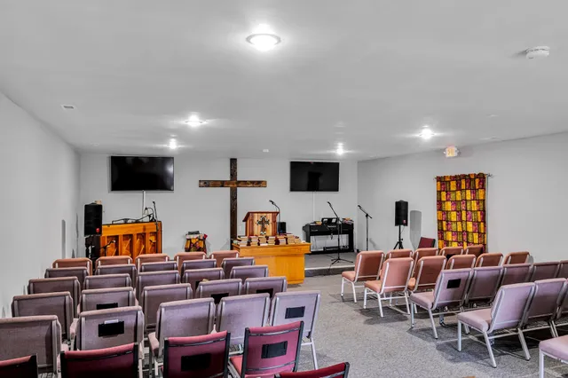 a living room with furniture kitchen and a flat screen tv